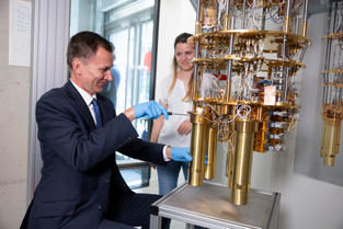 UK chancellor Jeremy Hunt loading a puck into a Quantum Motion dilution refrigerator. 