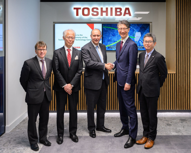 Fuve Toshiba and UK government officials shaking hands at the opening of the new quantum center Fuve Toshiba and UK government officials shaking hands at the opening of the new quantum center