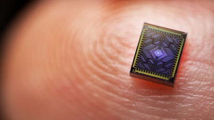 Intel's Tunnel Falls quantum chip on a person's fingertip
