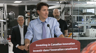 Justin Trudeau speaking from a lectern in a laboratory setting at Xanadu's headquarters
