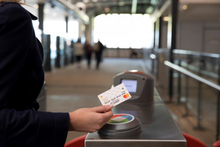 Someone making a contactless payment on public transport