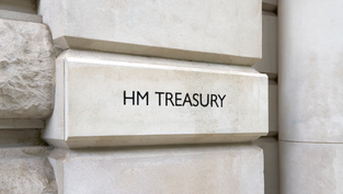The HM Treasury sign carved into the white external wall of its London office. 