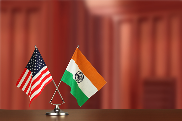India and U.S. flags on a desk India and U.S. flags on a desk