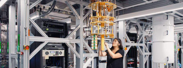 An IBM quantum computer and a researcher An IBM quantum computer and a researcher