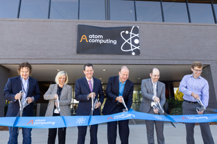 Four Atom Computing executives cut a ribbon outside a new facility.