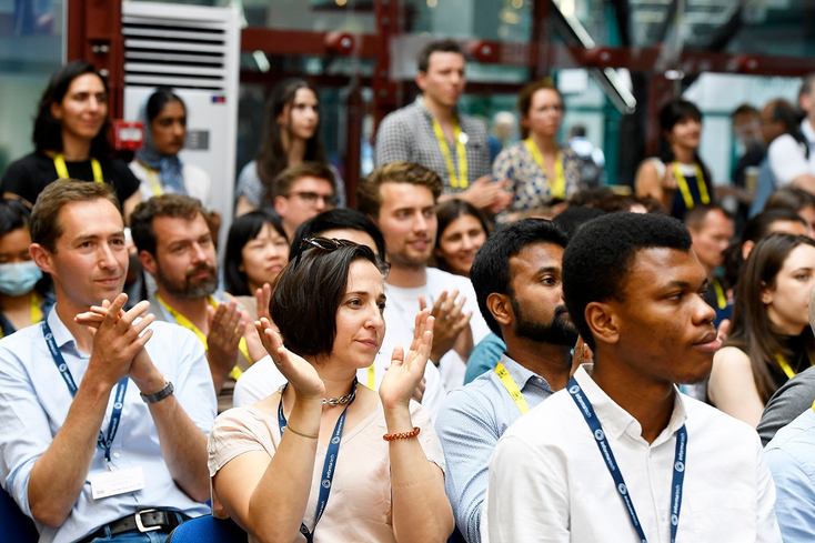 A clapping audience at the Quantum Summit