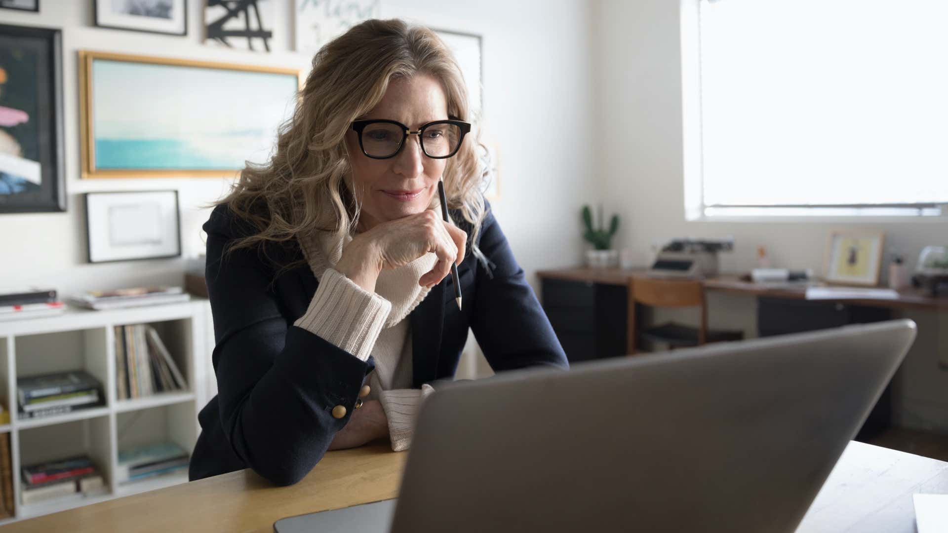 Woman reading from a laptop