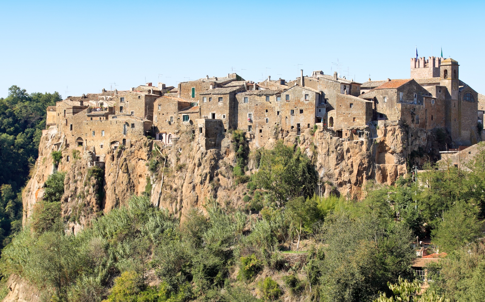 Calcata village, dramatically situated on a cliff, offers a breathtaking view of the greenery beneath.