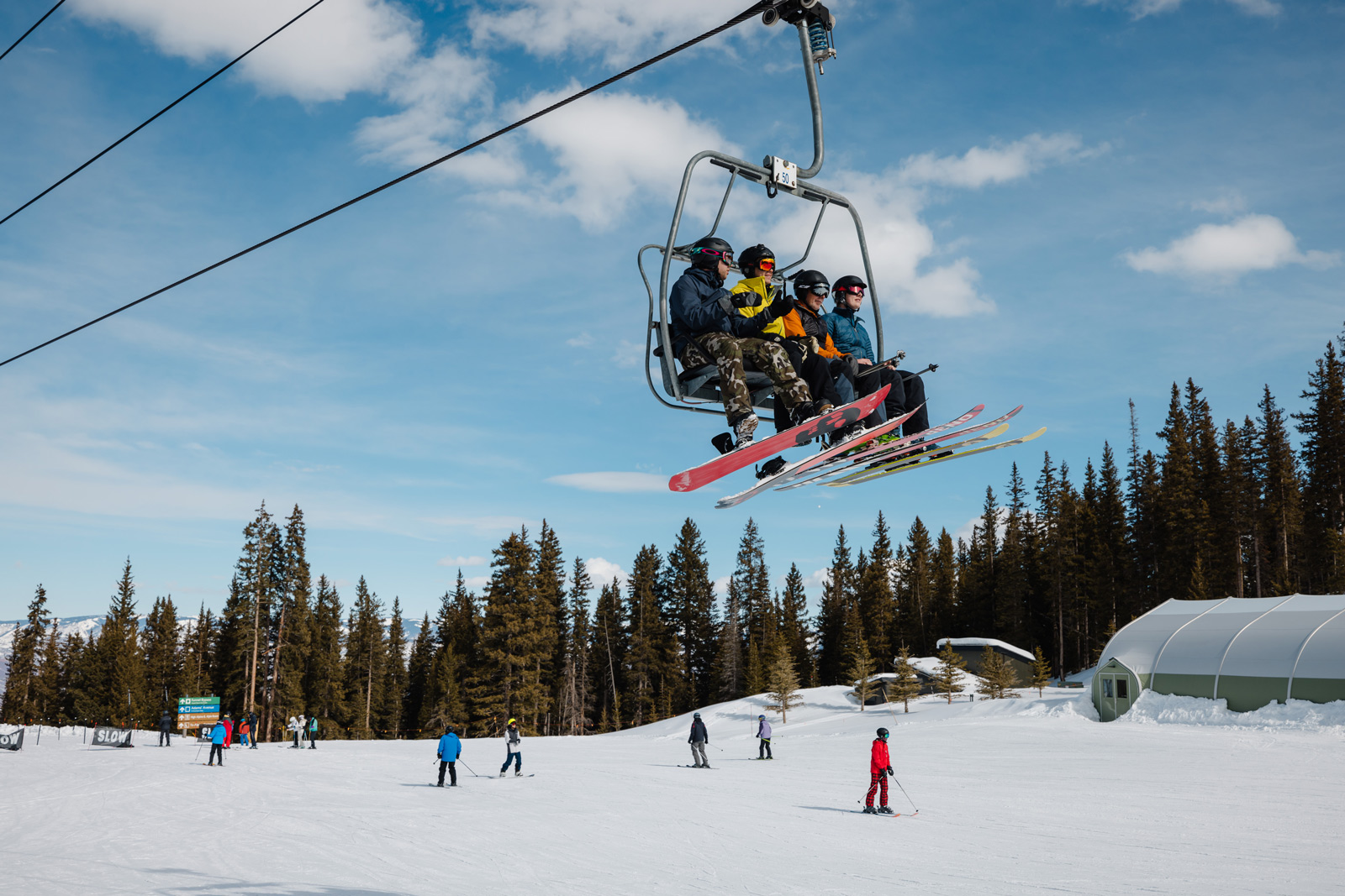 A ski lift in Aspen, Colorado, carrying passengers up a snowy mountain slope