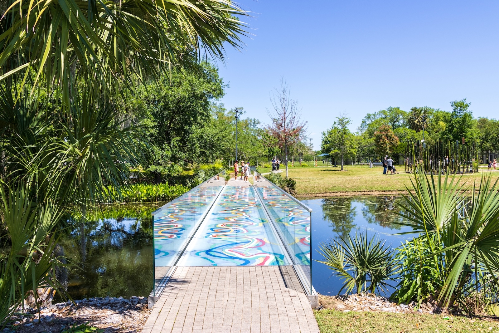 A vibrant bridge adorned with colourful designs, located in City Park, enhancing the park's lively atmosphere