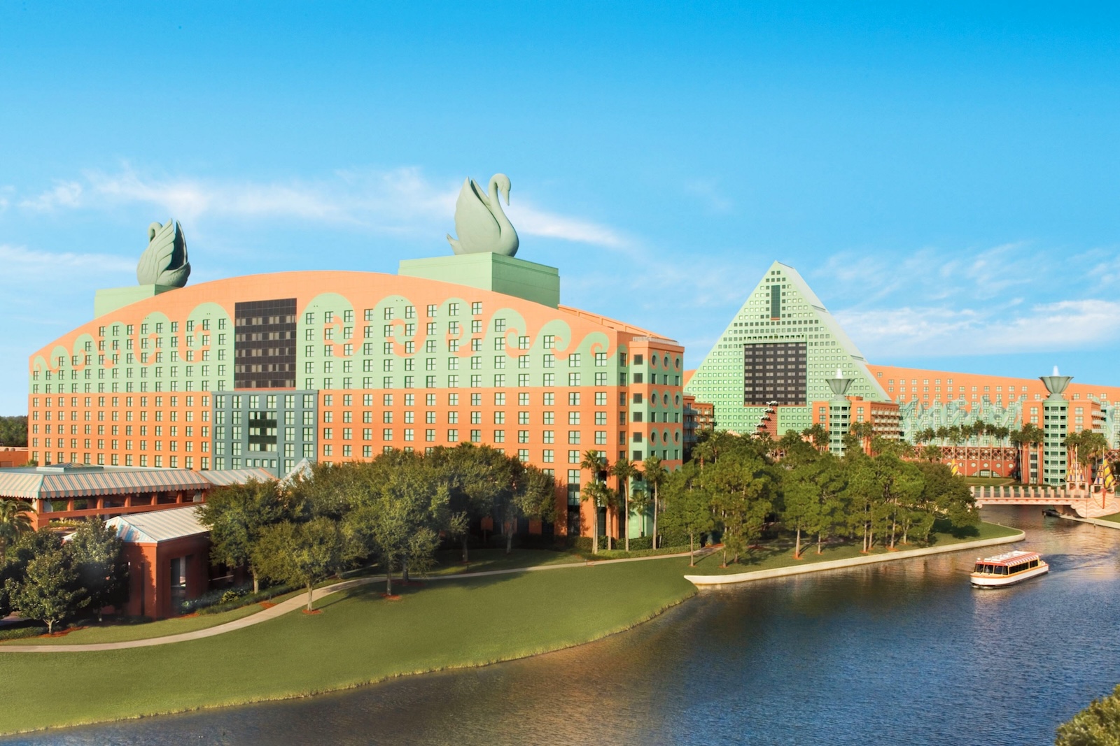 A scenic view of the elegant architecture of the Walt Disney World Swan. Two green swan statues sit on top of the building.