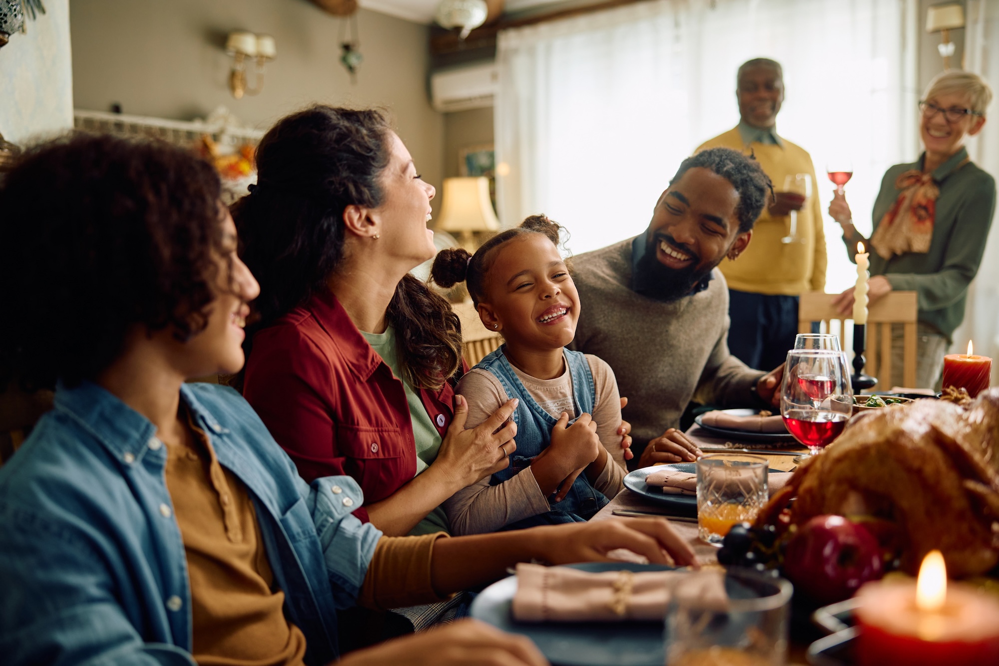 A family gathers around a table for Thanksgiving