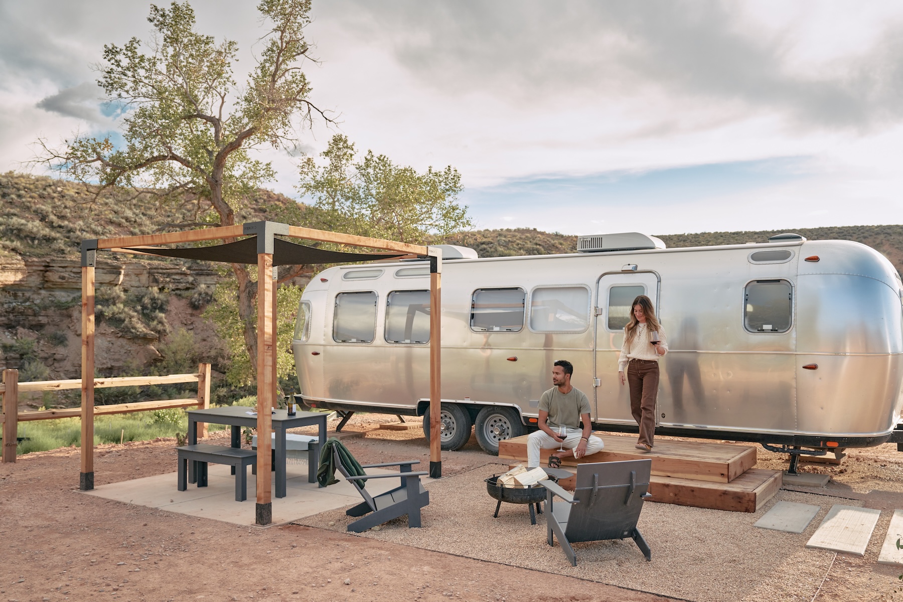 A shiny Airstream travel trailer nestled in the scenic beauty of Autocamp Zion, Utah, ready for adventure.