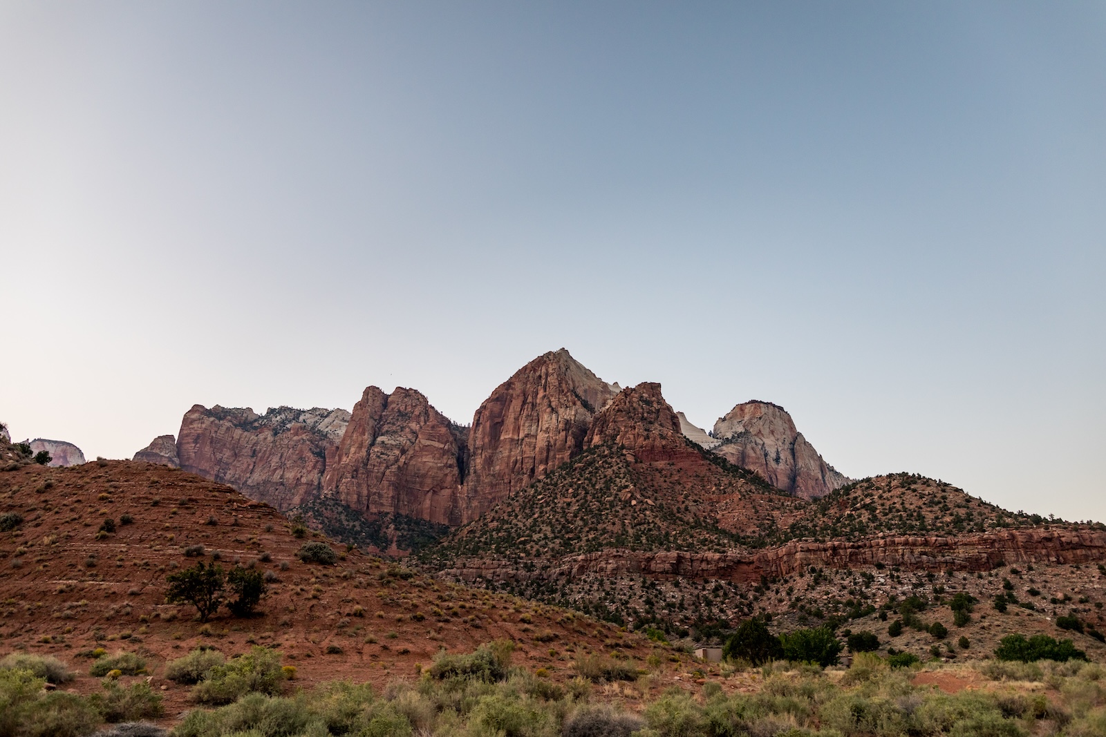 Towering rocky mountains in Zion National Park, showcasing the park's stunning natural beauty and rugged terrain.