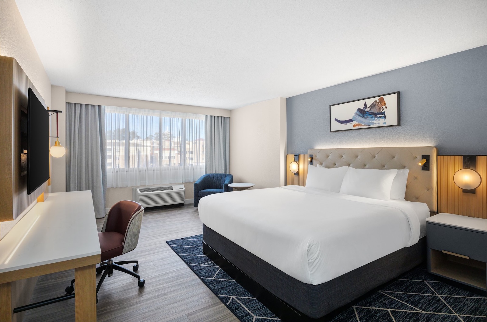 Hotel room at Crowne Plaza Virginia Beach Town Center featuring a bed, desk and television