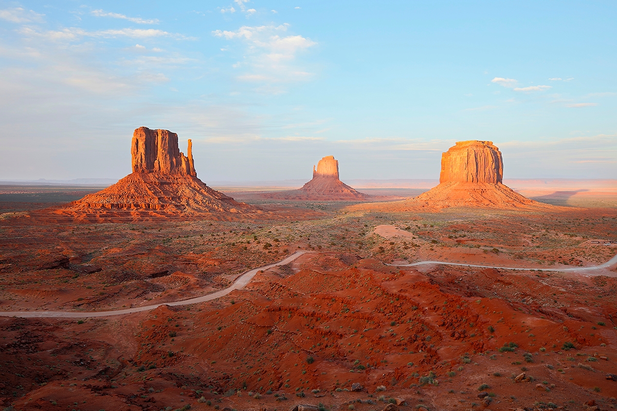 Aerial view of Monument Valley's stunning desert landscape, showcasing red rock formations and vast sandy expanses.