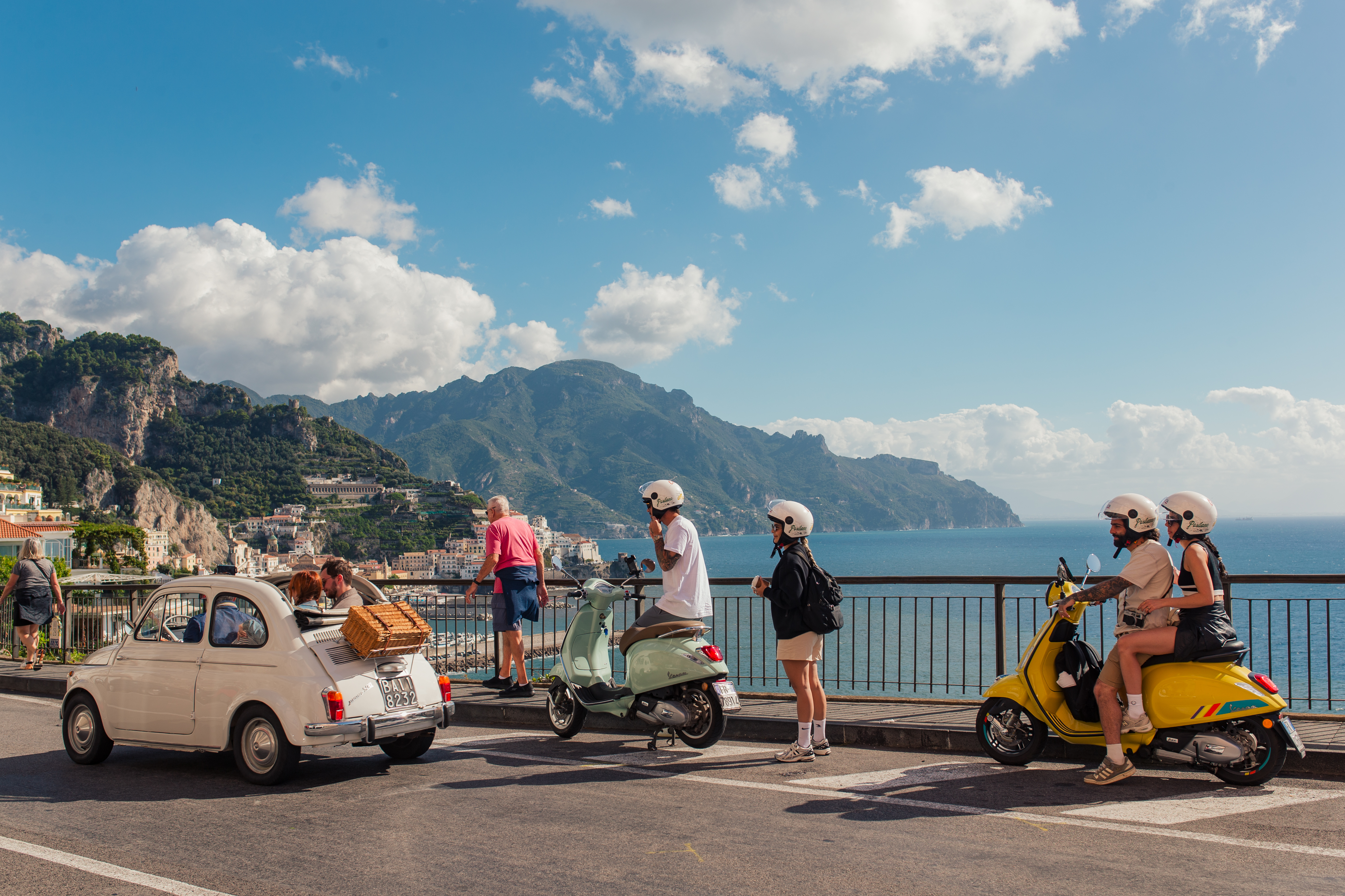 Vintage Fiat and scooters overlooking the Amalfi Coast.