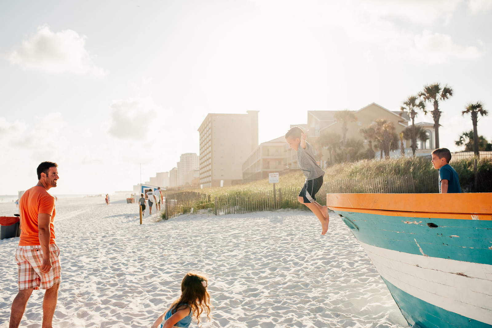 A family enjoying a sunny day at Palm Beach, Florida, playing and relaxing on the sandy shore.