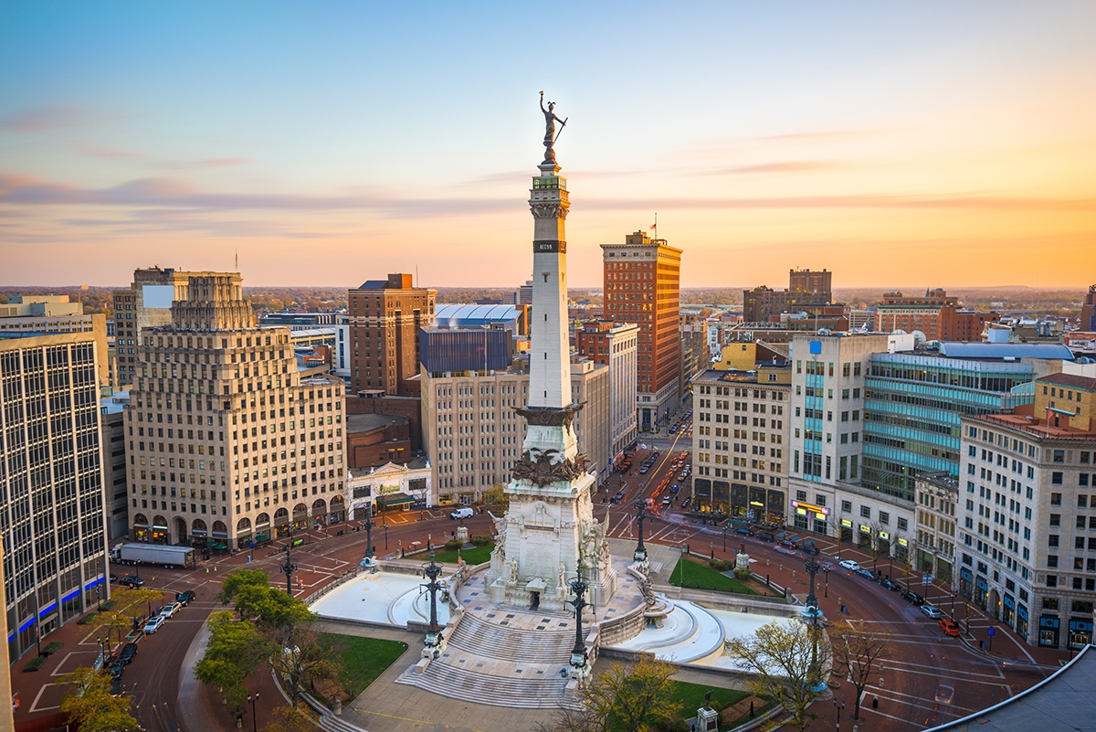 A scenic view of Indianapolis, Indiana, featuring a prominent monument at the center of the city skyline.