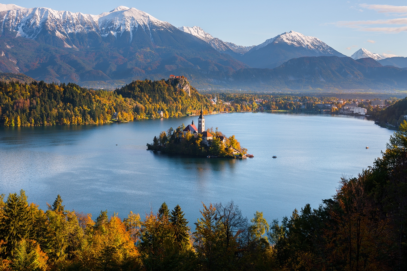 A serene view of Lake Bled, Slovenia, framed by mountains and green trees