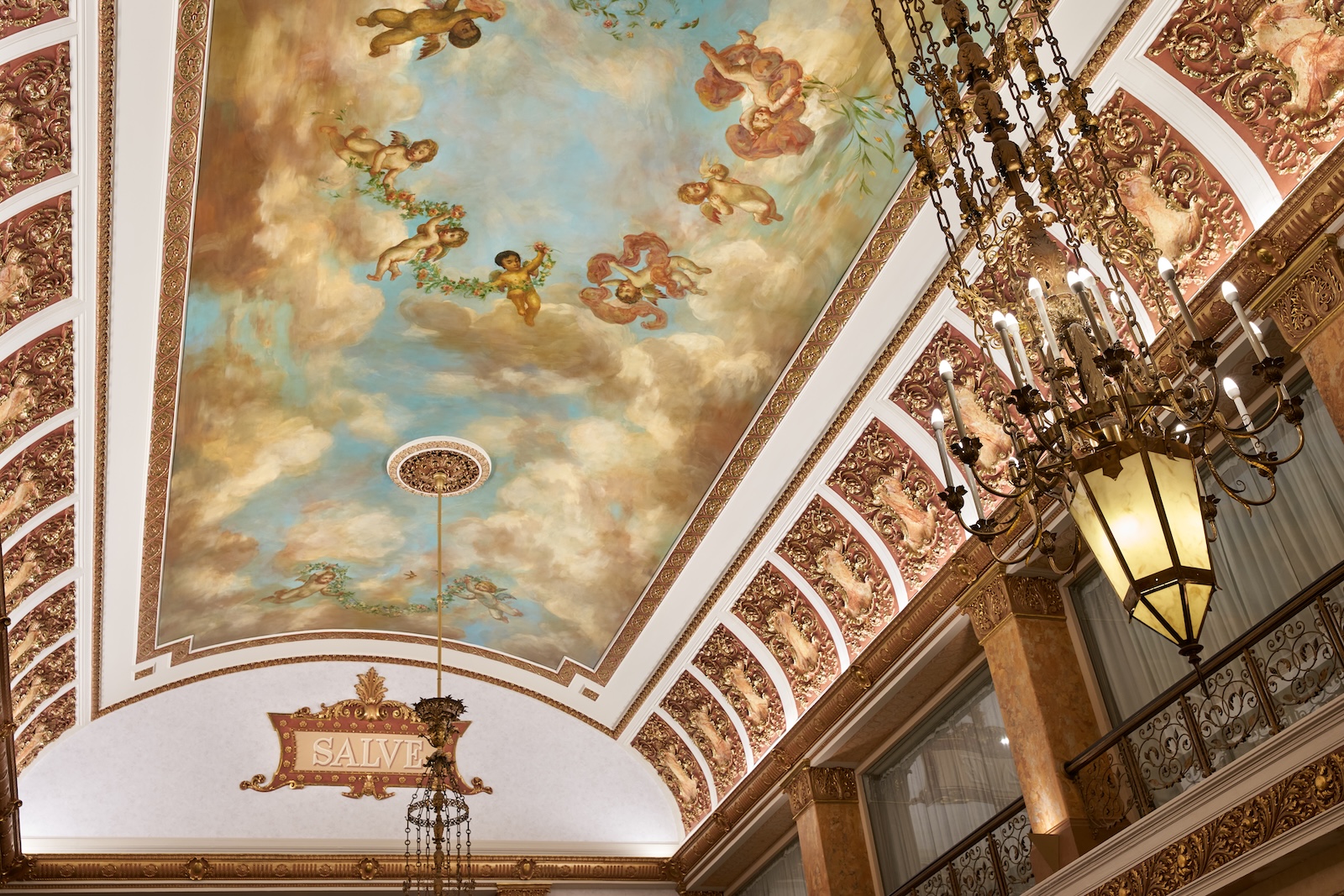 The Pfister Hotel lobby features a ceiling adorned with a painting of clouds