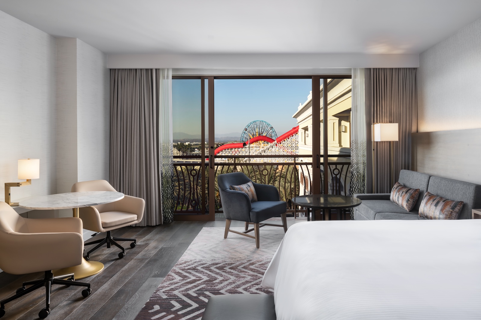 A hotel room in The Westin Anaheim Resort, featuring a ferris wheel with Disneyland in the background.