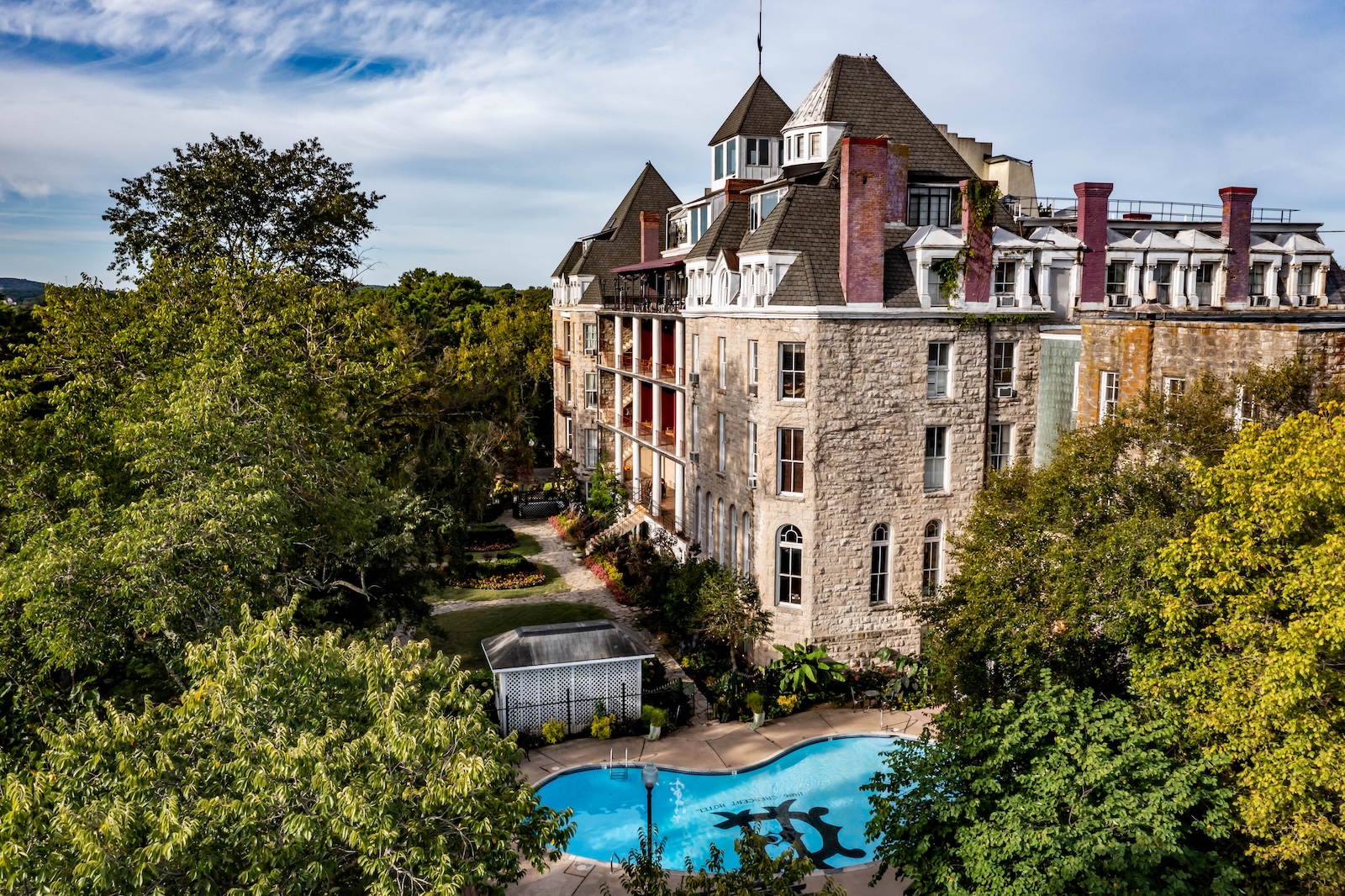  The 1886 Crescent Hotel and Spa, surrounded by trees, features a pool and a brisk fall atmosphere