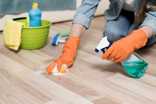 A person cleaning the floor with supplements