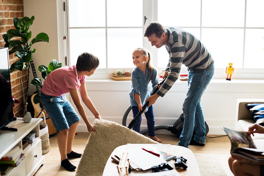 Man and kids cleaning livingroom