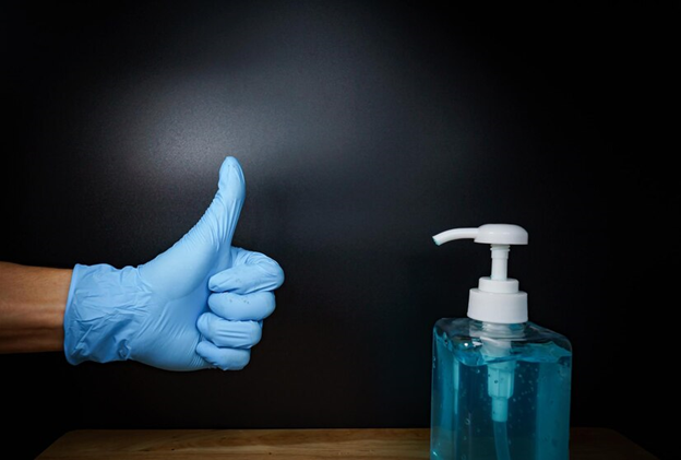 A hand in a glove giving a thumbs up