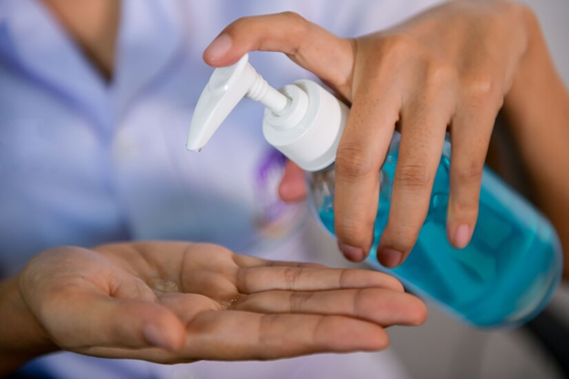 A person using a hand sanitizer
