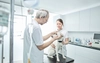 A veterinarian and assistant examine a dog.