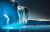 Antarctica Ice Cliff over Water with Small Boat of People