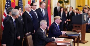 U.S. President Donald Trump (R) and China's Vice Premier Liu He, the country's top trade negotiator, sign a trade agreement b