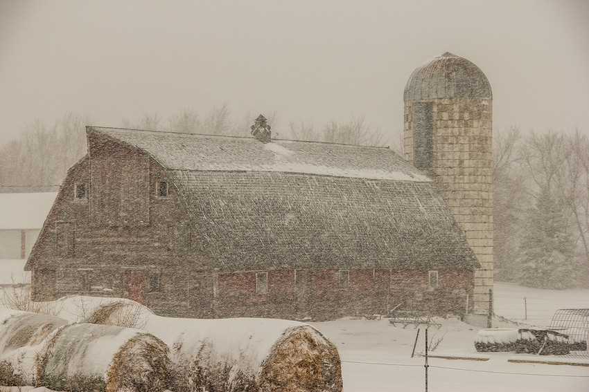 old barn and silo in a blizzard