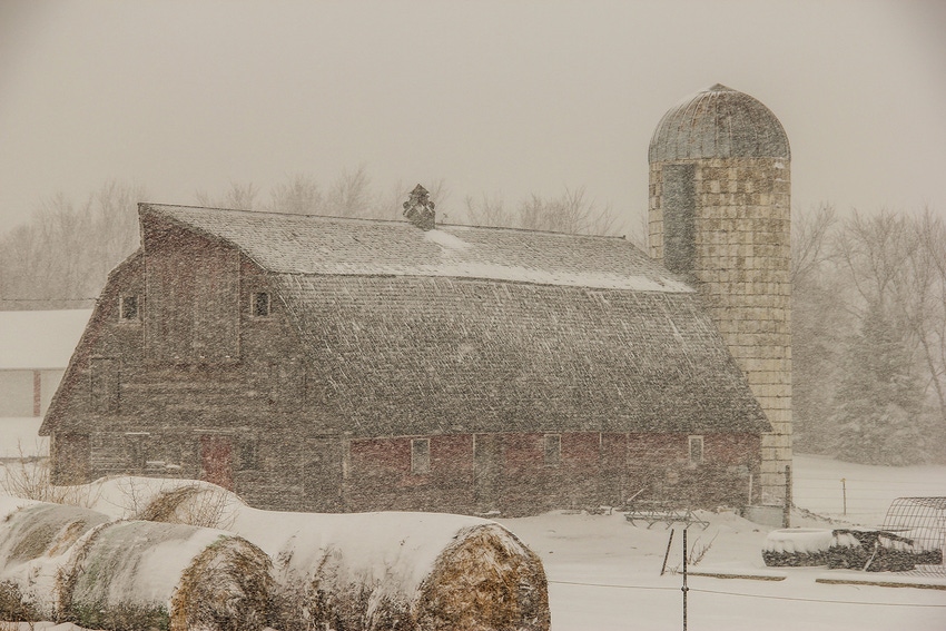 old barn and silo in a blizzard old barn and silo in a blizzard