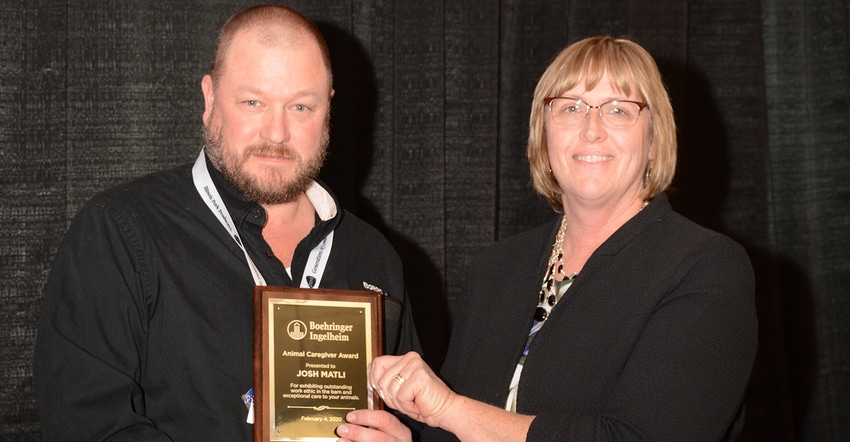 Pam Janssen presents Josh Matli his award as the Illinois Pork Producers Association Animal Caregiver of the Year.