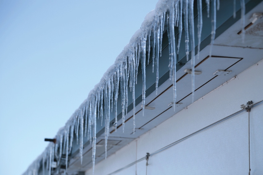 icicles hanging from the eave of a hog barn