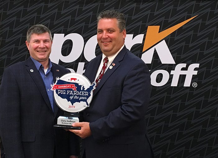 National Pork Board CEO Bill Even presents Chris Hoffman with the 2019-20 America’s Pig Farmer of the Year award.