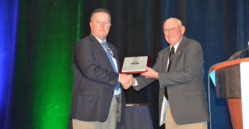 Everett Forkner, right, was inducted into the National Pork Producers Council Hall of Fame Thursday during the National Pork Everett Forkner, right, was inducted into the National Pork Producers Council Hall of Fame Thursday during the National Pork