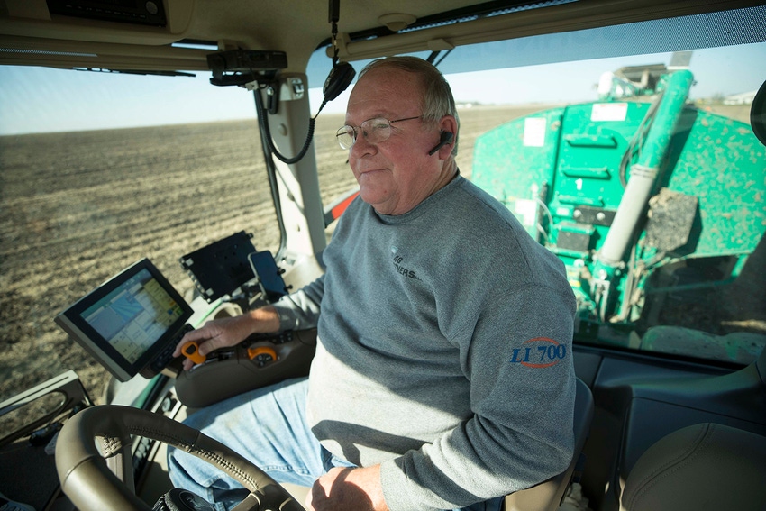 A farmer practicing good manure management. A farmer practicing good manure management.