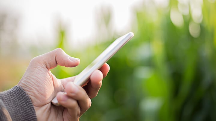 farmer using smartphone ag tech Getty Images