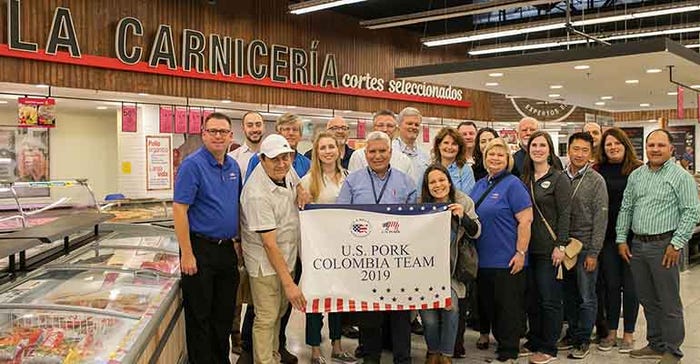 U.S. pork producers, industry leaders and U.S. Meat Export Federation staff pose for a group photo at a supermarket in Medellin, Colombia.