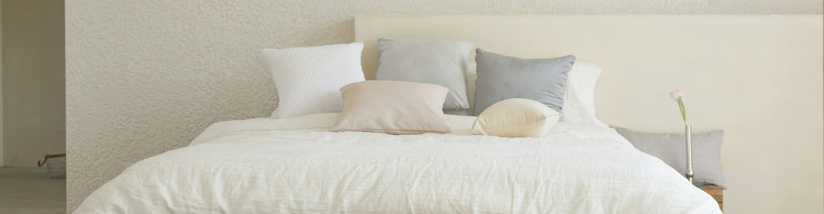 A cot with multiple pillows