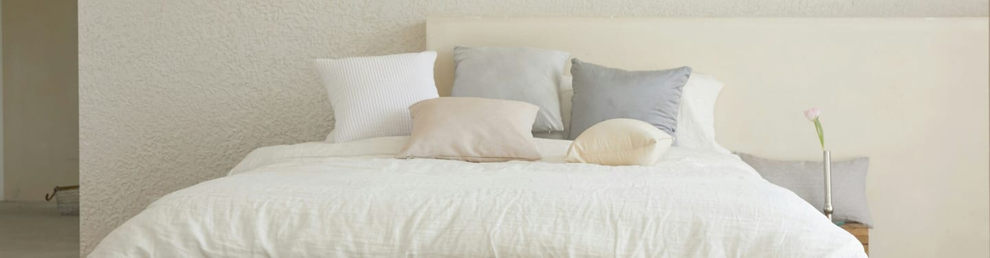 A cot with multiple pillows