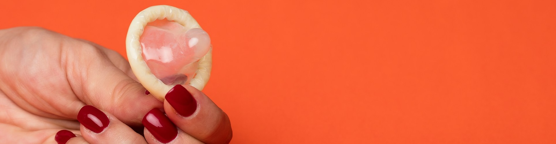 A person holding a condom