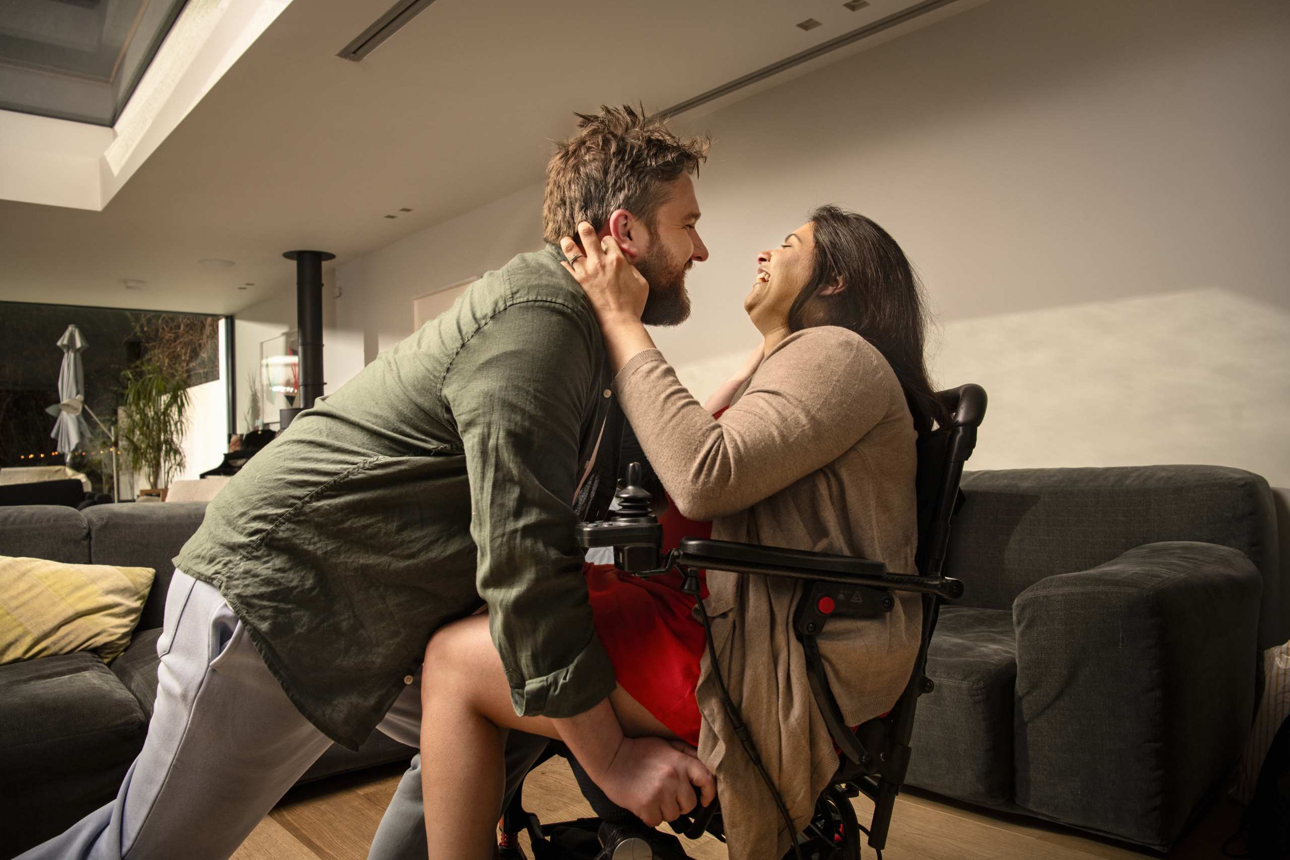 A man laughing with his wife in their home
