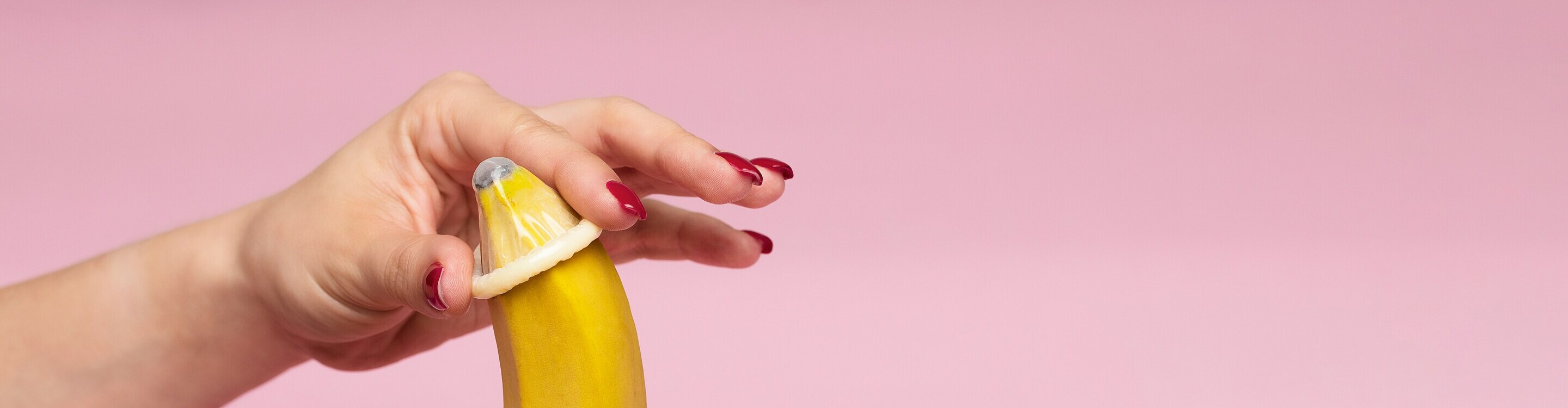 A person touching a strawberry