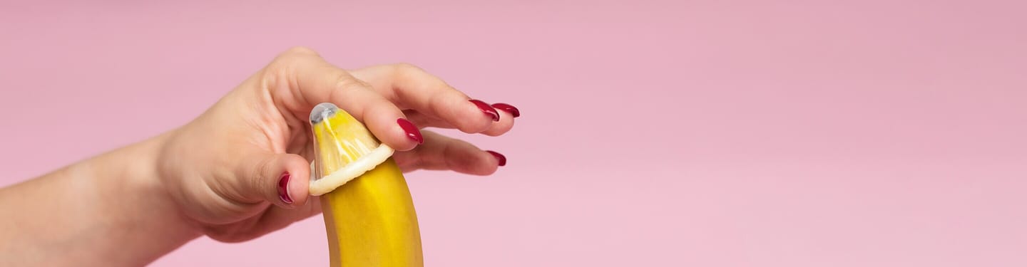 A person touching a strawberry