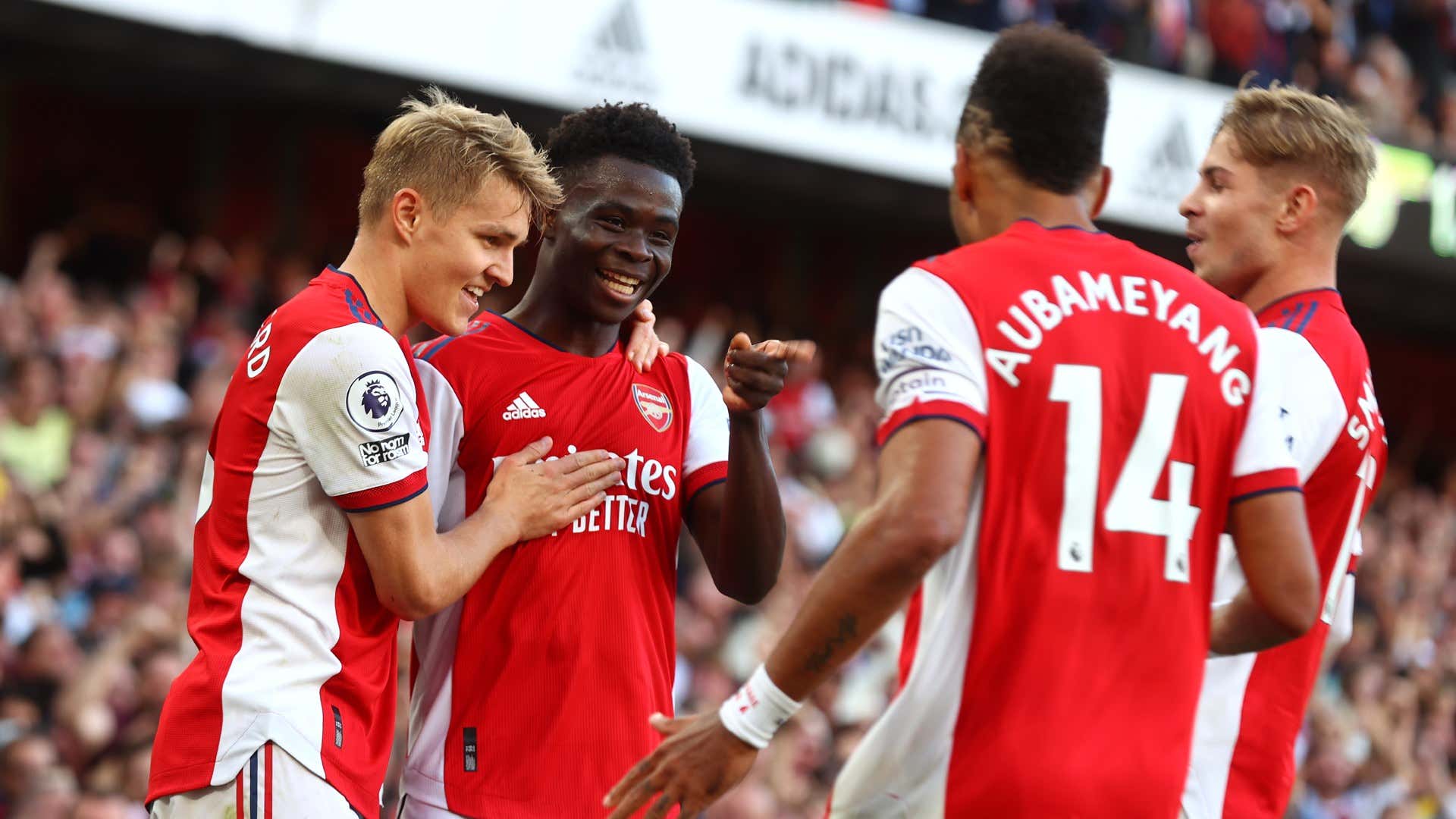 Bukayo Saka celebrates with Arsenal teammates